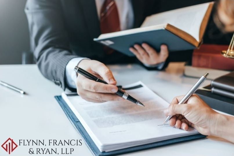 A lawyer looking over a document with a client